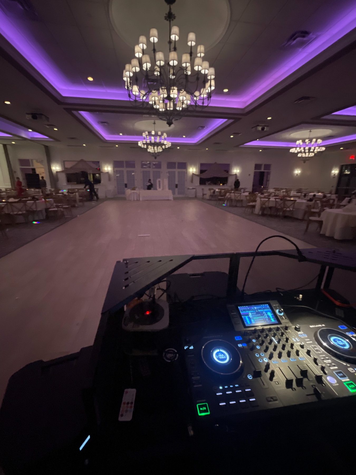 Ballroom dance floor with professional DJ lighting and reception setup
