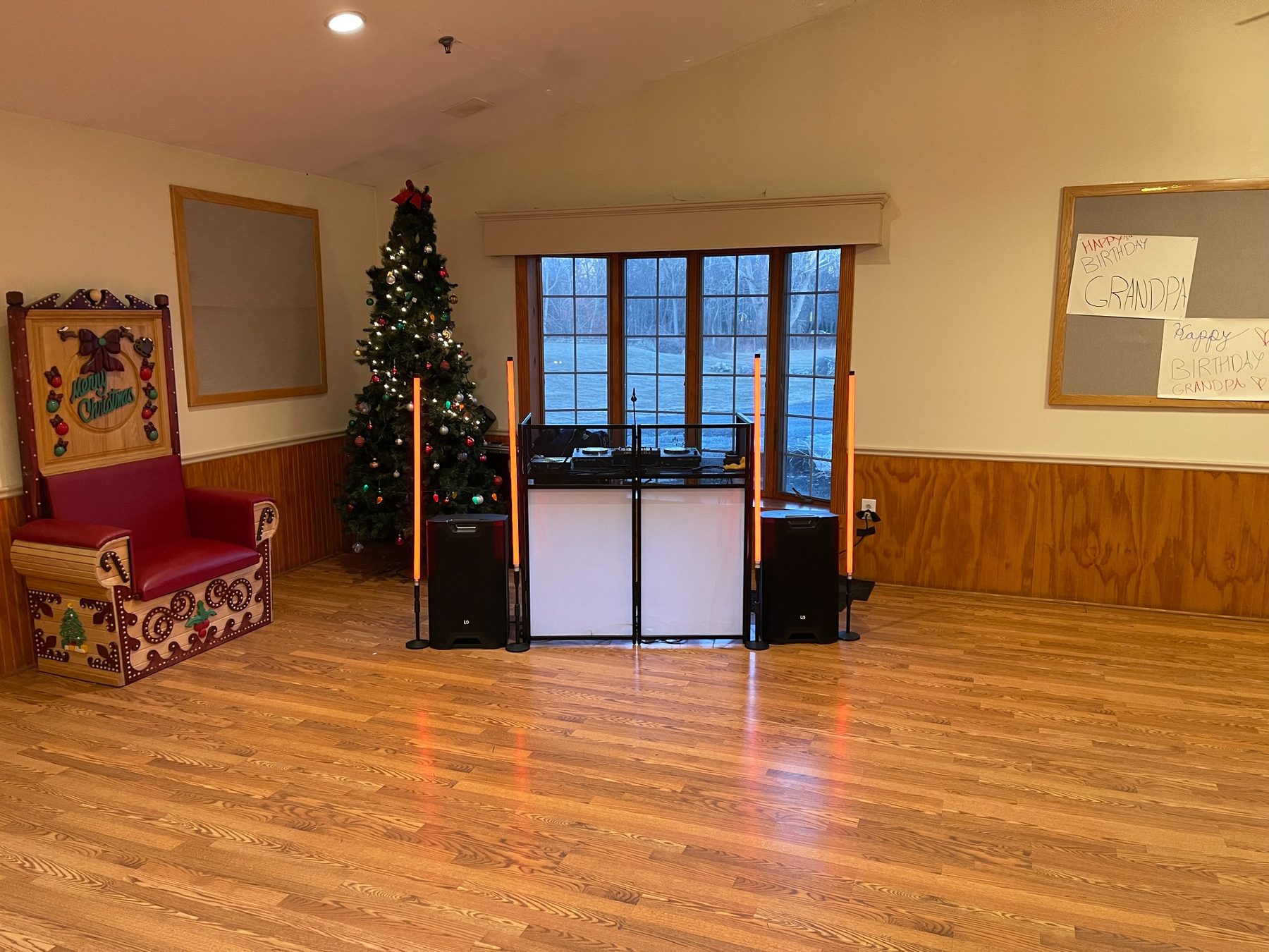 Professional DJ booth with speakers and vertical dance-floor lighting