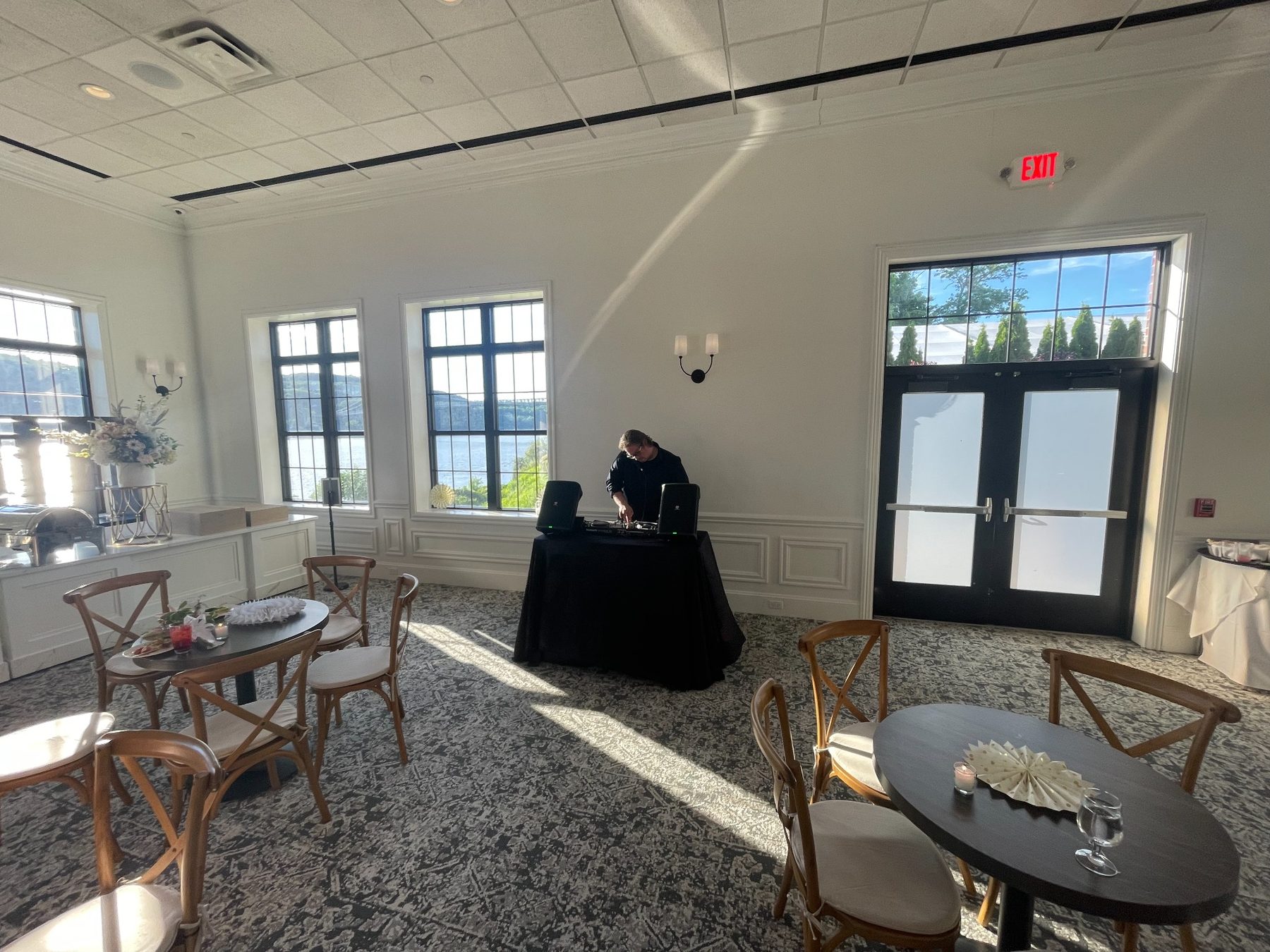 DJ setup in an elegant reception space with large windows