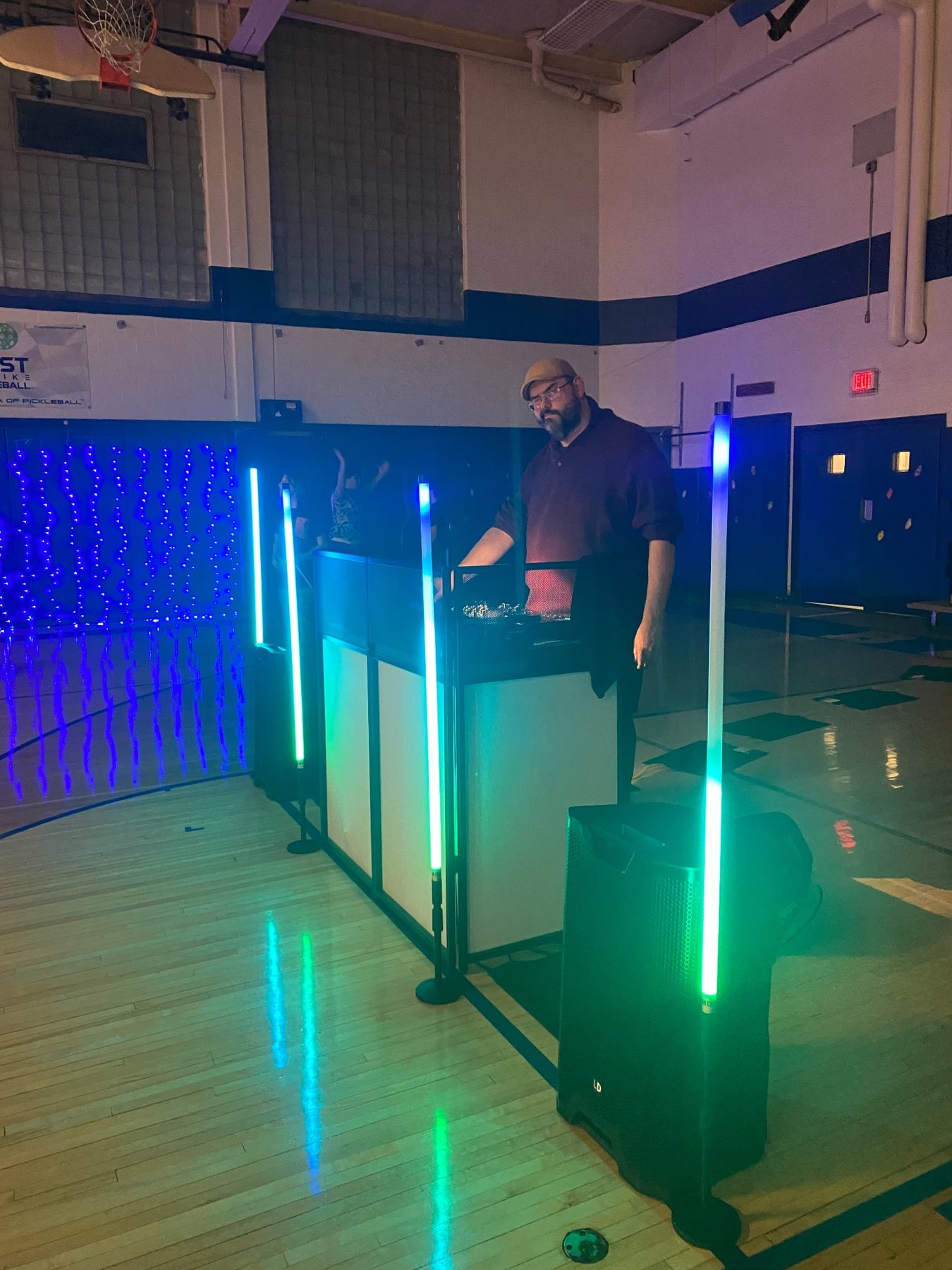 DJ Jesse B. performing at a school dance with colorful lighting
