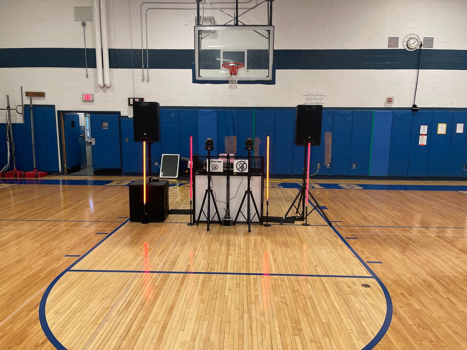 Professional DJ sound and lighting setup in a school gymnasium