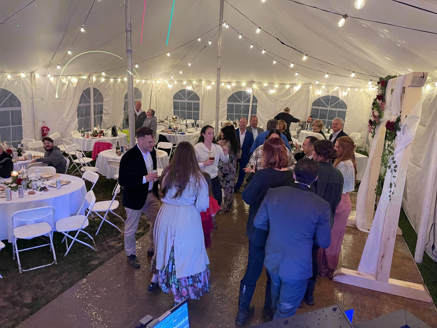 Guests dancing at a tented wedding reception
